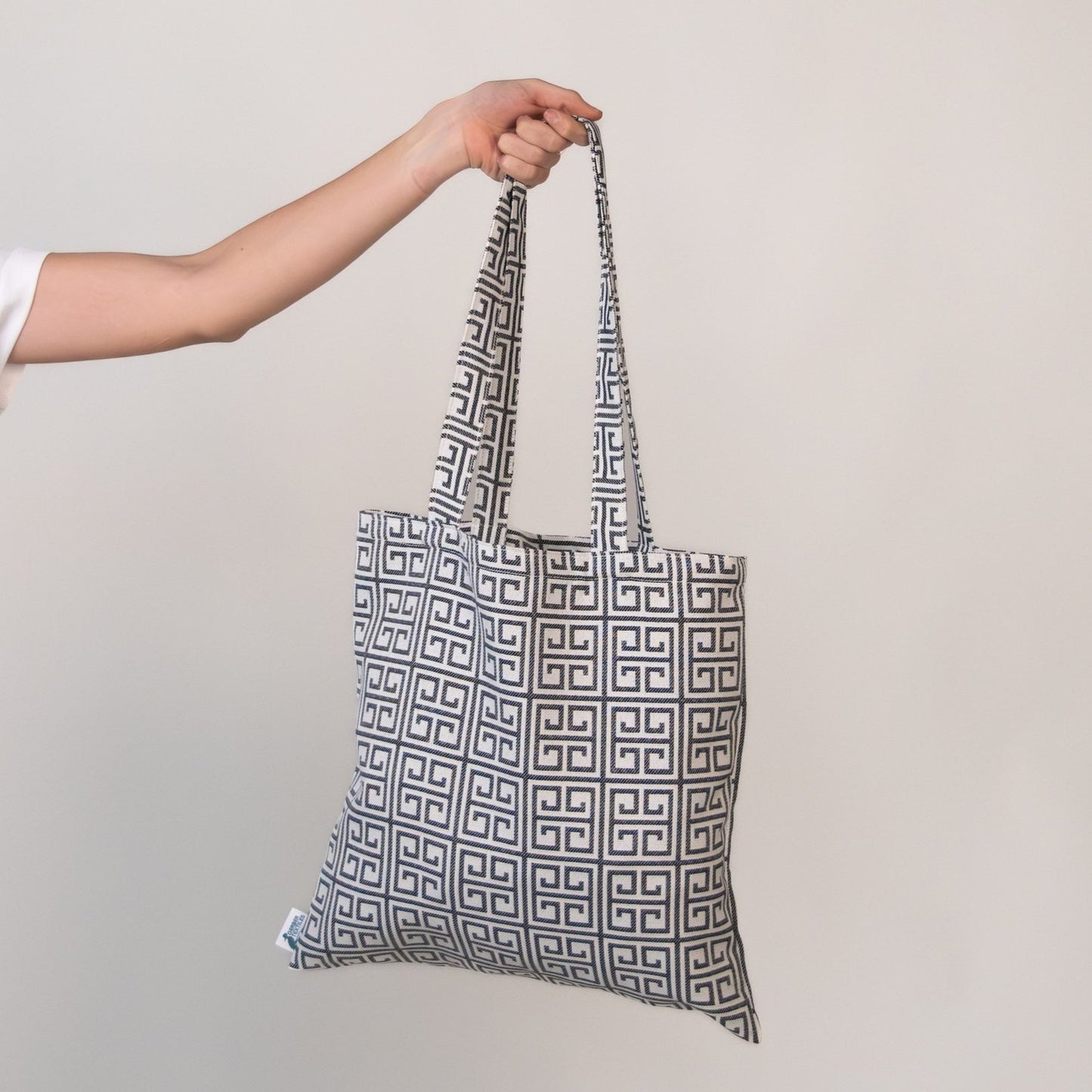 Terrace Black Tote featuring geometric black and white Greco-style pattern on water-resistant outdoor fabric.